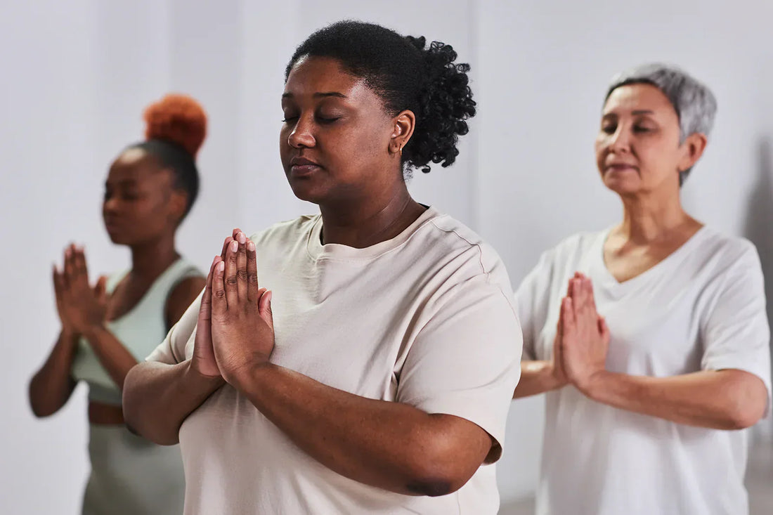 Three women practicing yoga in a room to feel fresh and energetic